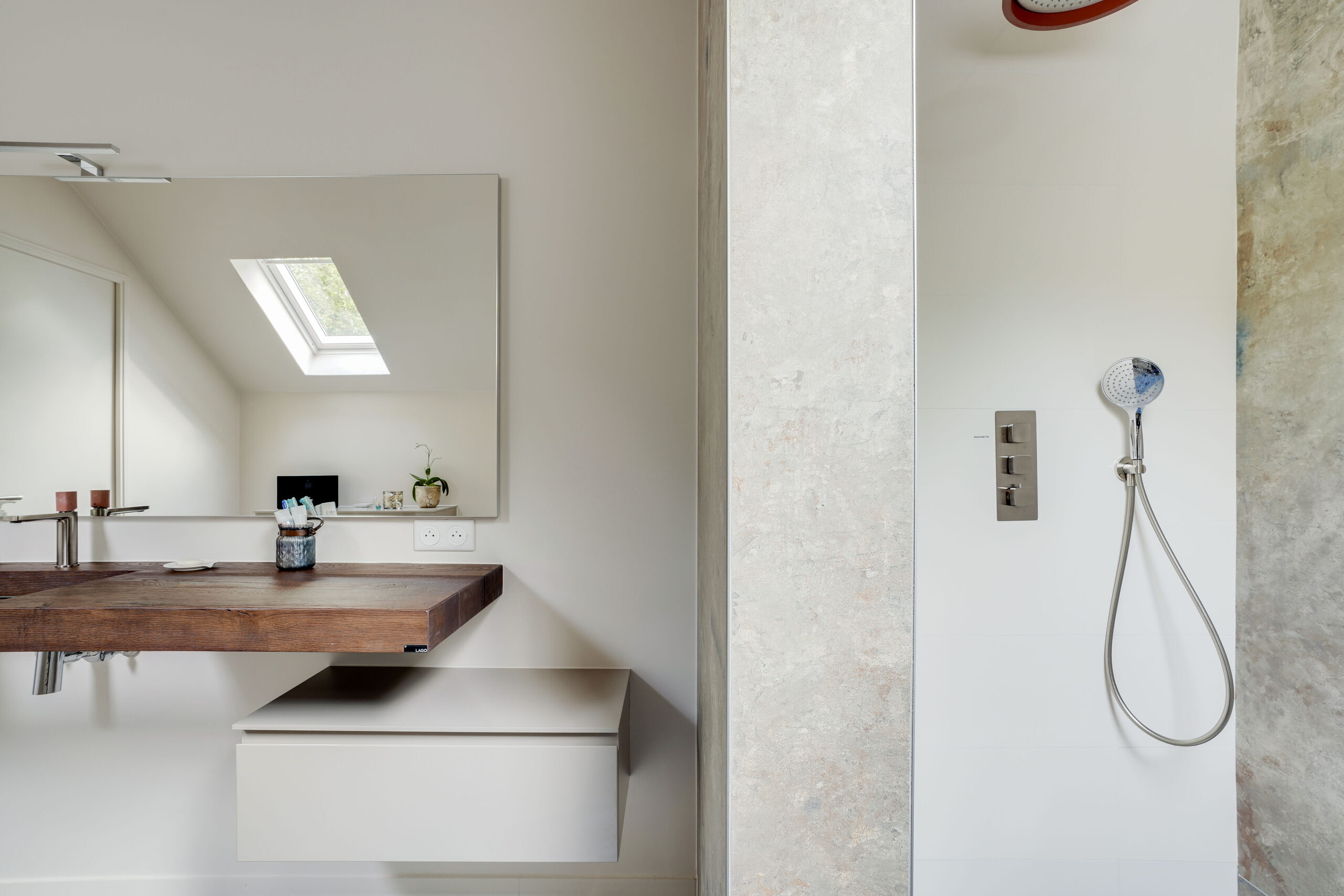 Vue d'ensemble de la salle de bains sous combles avec plan vasque en bois et accès à la douche italienne, réalisation Dec Home